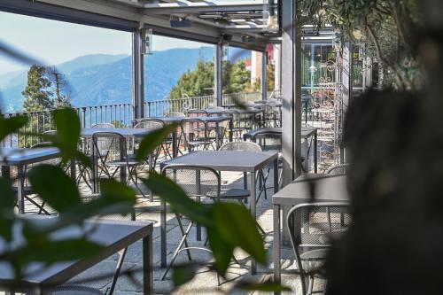a row of tables and chairs on a balcony at Casa Vacanze Panorama in Brunate