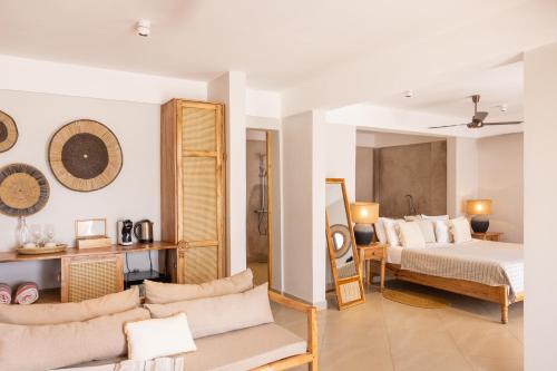 a living room with a bedroom and a bed at Kaskazi Hotel Zanzibar in Jambiani