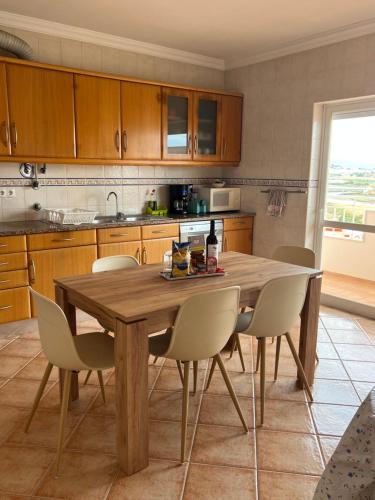 a kitchen with a wooden table and chairs at Apart. Arco-Iris - Amazing view in Lagos