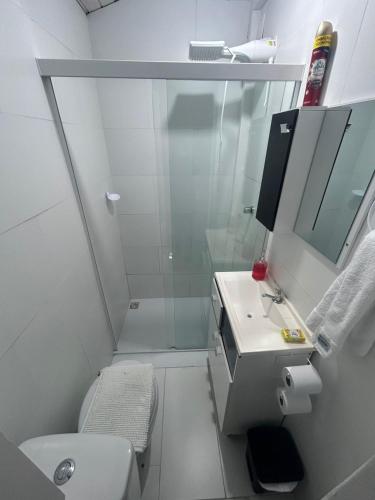 a bathroom with a shower and a toilet and a sink at Casa Pérolas do Mar in Balneário Camboriú