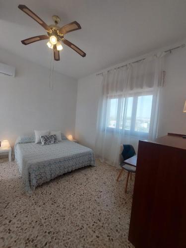 a bedroom with a bed and a ceiling fan at Terrazza sul mare in Scicli