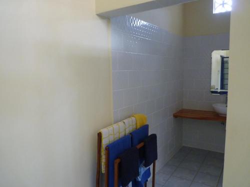 a bathroom with blue and white tiles and a sink at FRIDULI SHILOH Resort in Diani Beach