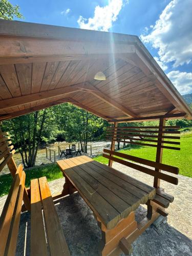 a wooden picnic bench under a pavilion in a park at Rest House in Olovo