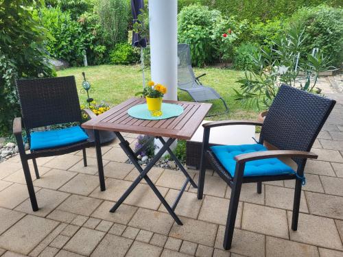 a wooden table and two chairs on a patio at Haus Obere Weinburg in Radolfzell am Bodensee