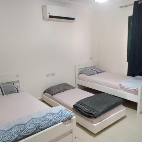 a room with three bunk beds in it at See your sea in Ras Sedr