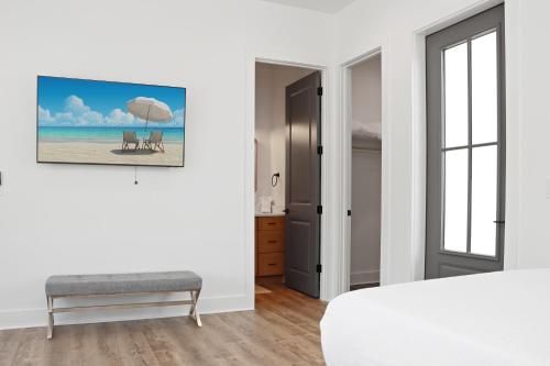 a bedroom with a bed and a bench and an umbrella at Highball Heaven by Pristine Properties Vacation Rentals in Port Saint Joe