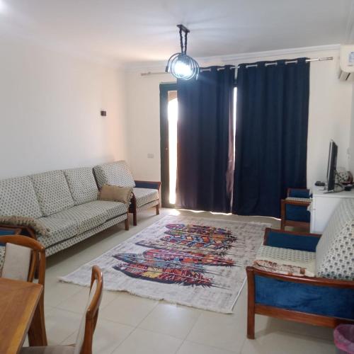 a living room with a couch and a rug at See your sea in Ras Sedr