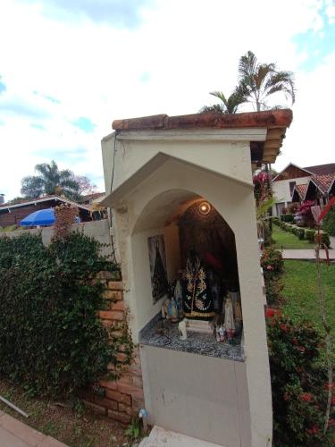 a small shrine in the backyard of a house at Pousada Mon Desir in Penedo