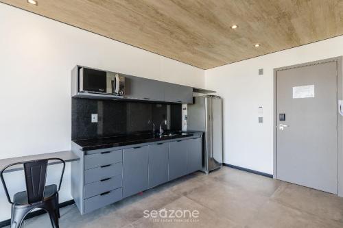 a kitchen with a sink and a microwave at NWTs - Estúdios em Prédio com Vista Mar in Maceió