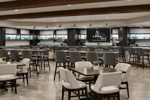 a restaurant with tables and chairs and a bar at DoubleTree by Hilton Bloomington Minneapolis South in Bloomington