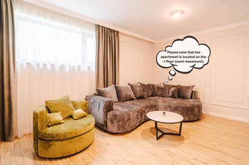 a living room with a couch and a chair at Stylish Stay - Workspace & Netflix Included in Cluj-Napoca