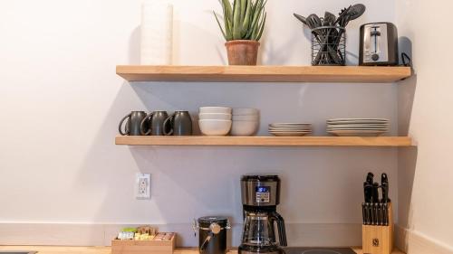 a kitchen with wooden shelves and a coffee maker at High Creek Lodge and Cabins in Pagosa Springs
