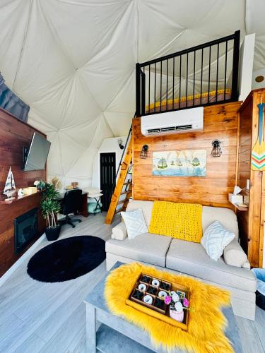 a living room with a couch in a tent at Island Beach Hideaways in Pomquet
