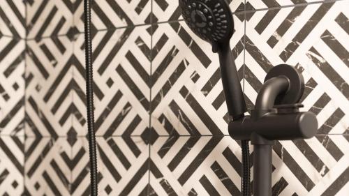 a hair dryer on a wall with a pattern at High Creek Lodge and Cabins in Pagosa Springs
