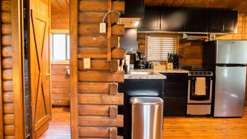 a kitchen with a stove and a refrigerator at High Creek Lodge and Cabins in Pagosa Springs