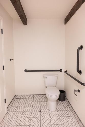 a bathroom with a white toilet and a tile floor at High Creek Lodge and Cabins in Pagosa Springs