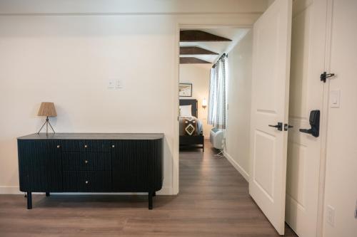 a hallway with a black dresser and a bedroom at High Creek Lodge and Cabins in Pagosa Springs