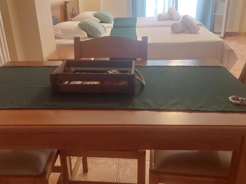 a table in a room with two beds at Rouchotas Studios by Viktor 1rst Floor in Argostoli