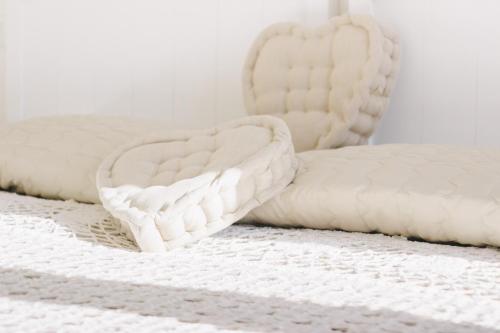 a white bed with two pillows on it at Il Cuore delle Apuane in Antona