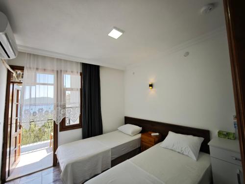 Postel nebo postele na pokoji v ubytování Kaptan Pansiyon