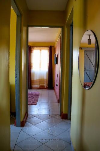 a hallway of a house with a mirror on the wall at Kristina Homes in Voi
