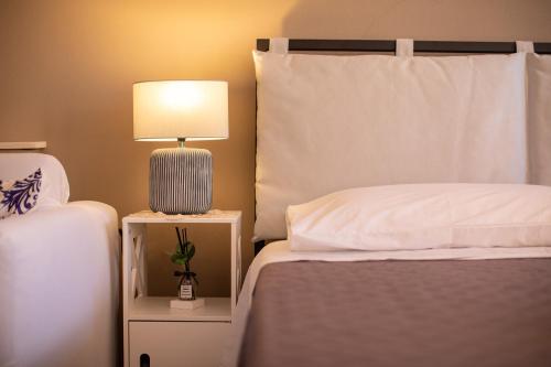 a bedroom with two beds and a lamp on a night stand at Diego Pool-Suite in Gello