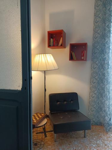 a living room with a chair and a lamp and a chairearcher at Dimora FinAmore 29 - Casa Vacanze in Lanciano