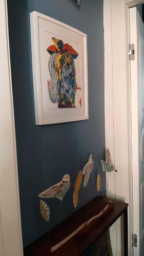 a painting on a blue wall with birds on it at Dimora FinAmore 29 - Casa Vacanze in Lanciano