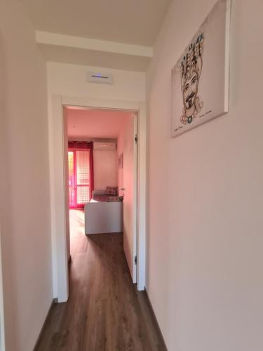 a room with a hallway with a painting on the wall at Emanuela Appartaments in Furnari