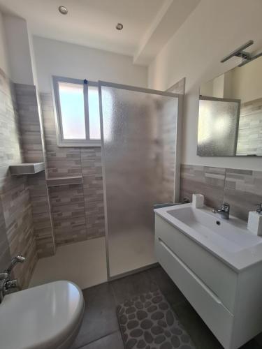 a bathroom with a toilet and a sink and a shower at Emanuela Appartaments in Furnari