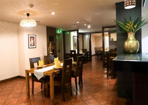 a dining room with a table and chairs in a restaurant at Radisson Blu Dhaka Water Garden in Dhaka