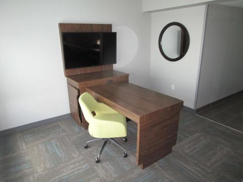 a desk with a television and a chair in a room at Best Western Cy-Fair in Houston