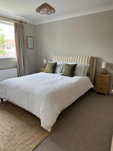 a bedroom with a white bed and a window at Cosy home for 2 in Alnwick in Alnwick