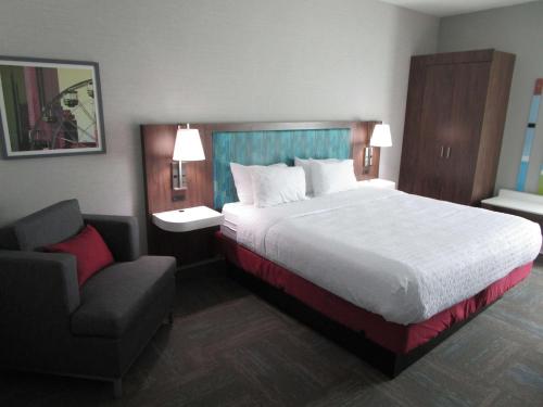 a hotel room with a bed and a chair at Best Western Cy-Fair in Houston