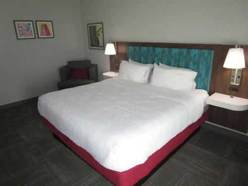 a hotel room with a large bed and a chair at Best Western Cy-Fair in Houston