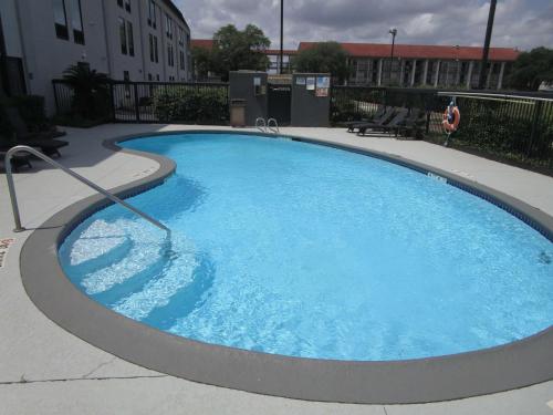 a large pool with blue water in a building at Best Western Cy-Fair in Houston