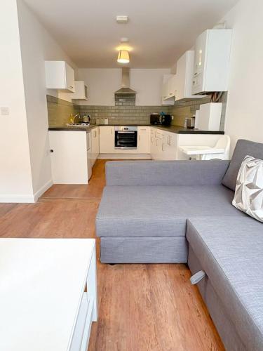 a living room with a couch and a kitchen at 58d Thorpe road in Norwich