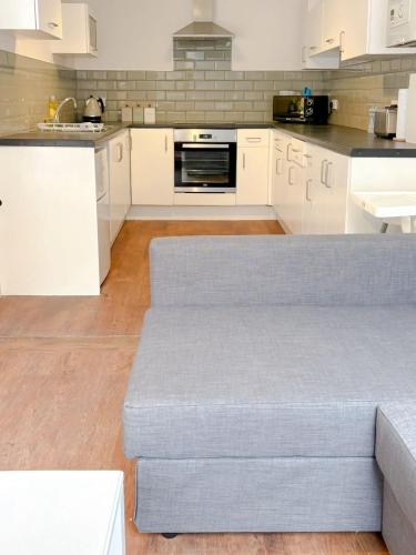 a living room with a couch in a kitchen at 58d Thorpe road in Norwich