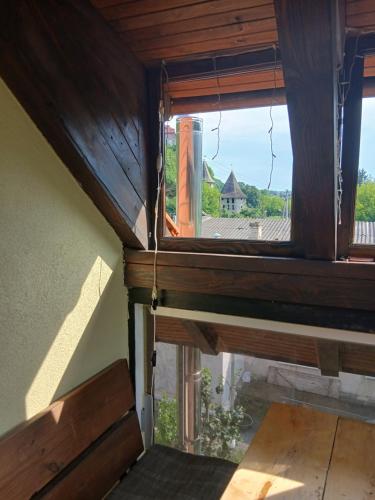 a window in a room with a view of a house at Romantic Guest House in Kamianets-Podilskyi