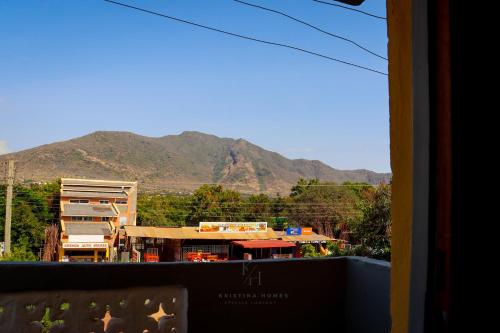 a view of a city from a window with mountains at Kristina Homes in Voi