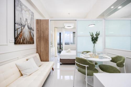 a living room with a couch and a table at Primeworld District Condo - Near Mactan Airport in Lapu Lapu City