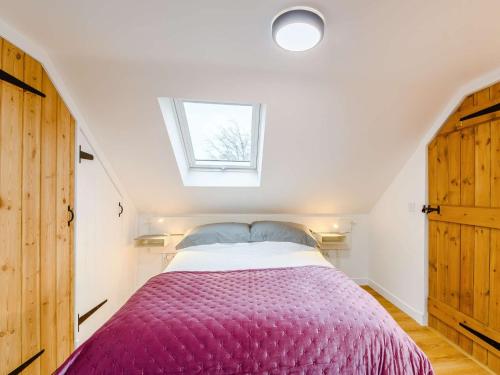 a bedroom with a bed with a purple blanket at 3 Bed in Lockerbie 89406 in Lockerbie