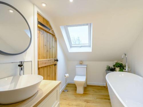 a bathroom with a sink and a tub and a toilet at 3 Bed in Lockerbie 89406 in Lockerbie