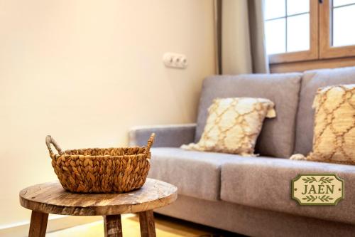 a living room with a couch and a basket on a table at Mi Andalusia Hotel Experience in Málaga