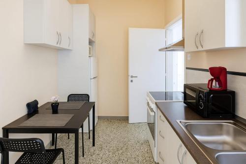 a small kitchen with a table and a microwave at Beachfront Bliss Oasis in Melission
