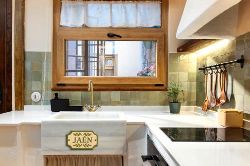 a kitchen with a sink and a window at Mi Andalusia Hotel Experience in Málaga