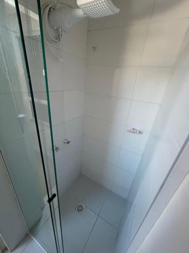 a walk in shower with a glass door at Casa Pérolas do Mar in Balneário Camboriú