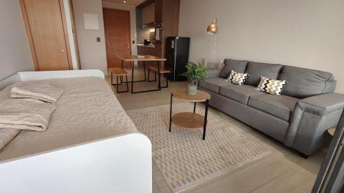 a living room with a bed and a couch at Oceana Suites Santo Domingo in Santo Domingo