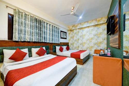 a hotel room with two beds and a television at Hotel Paradise Classic At Airport in New Delhi