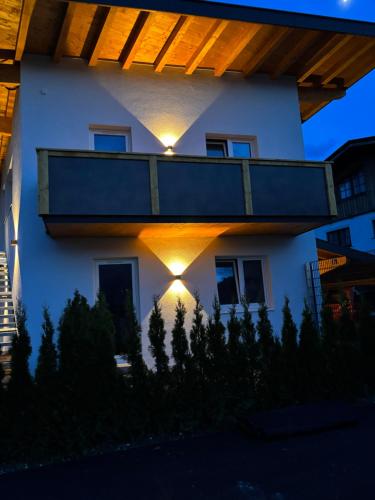 a house with lights on the side of it at Ferienwohnungen N & C in Sankt Johann in Tirol